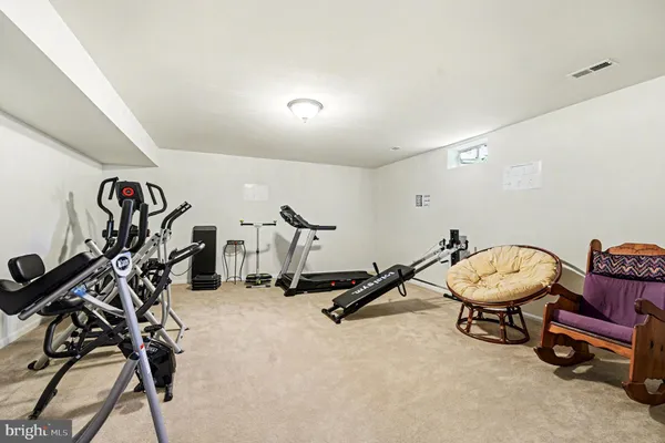 a room with gym equipment and white walls