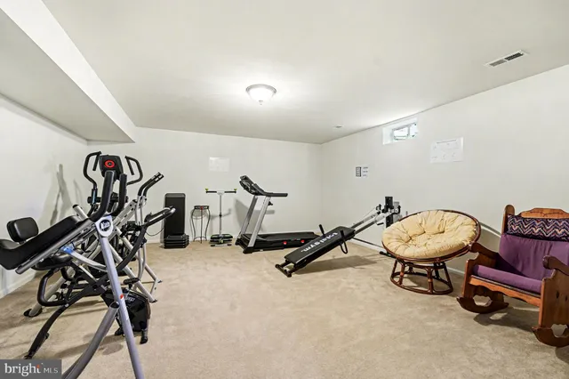 a room with gym equipment and white walls
