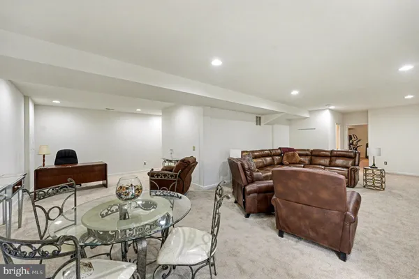 a living room with furniture a couch and kitchen view