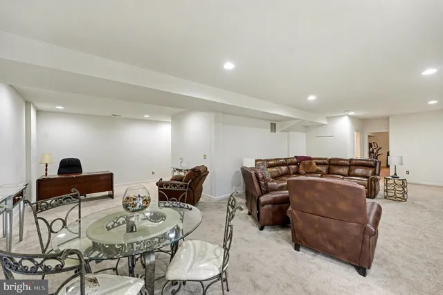 a living room with furniture a couch and kitchen view