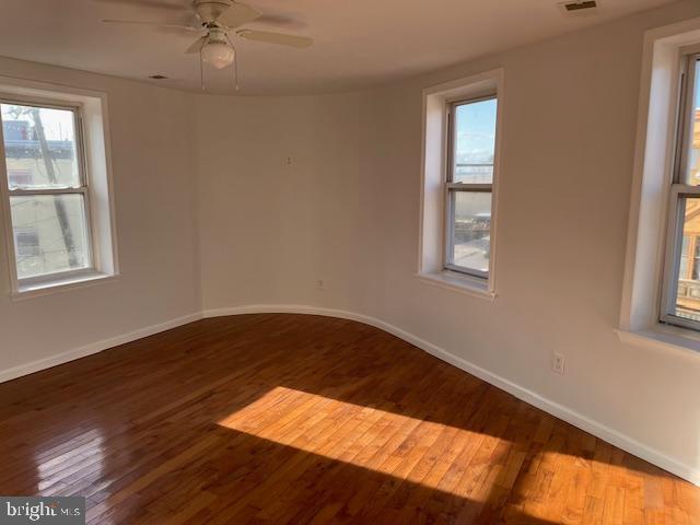2154 Ridge Avenue, Unit 3 Philadelphia, PA 19121 - Photo 10 of 27 a view of an empty room with wooden floor and a window