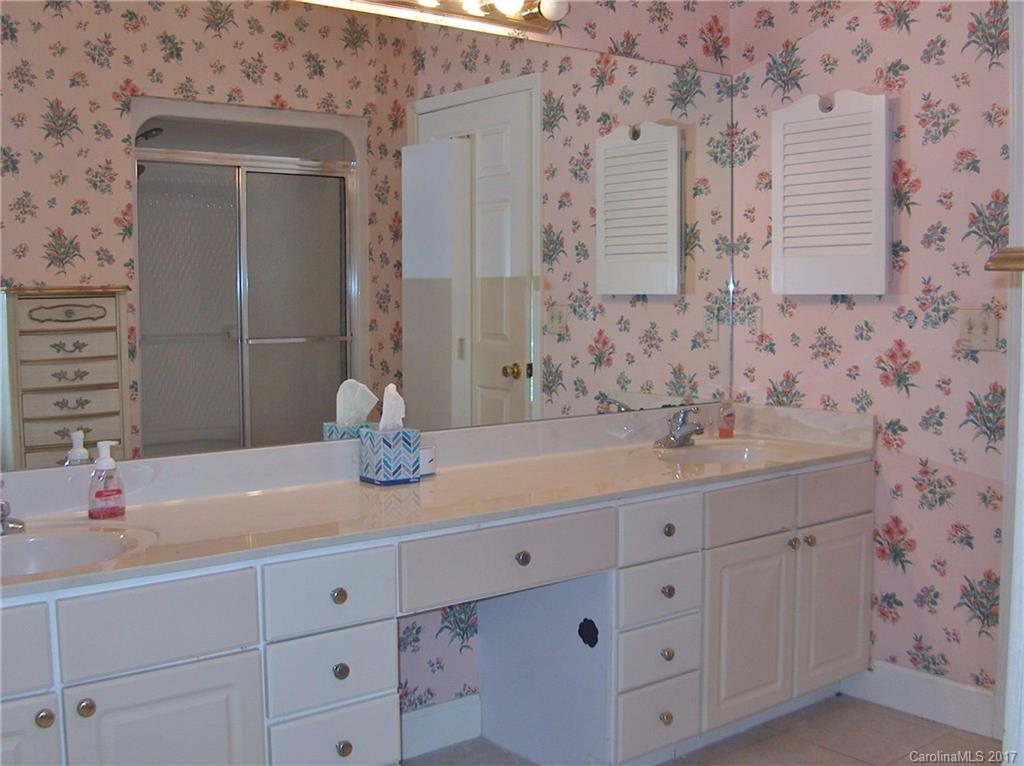 48 Falling Spring Road Clyde, NC 28721 - Photo 14 of 24 a bathroom with a sink and mirror