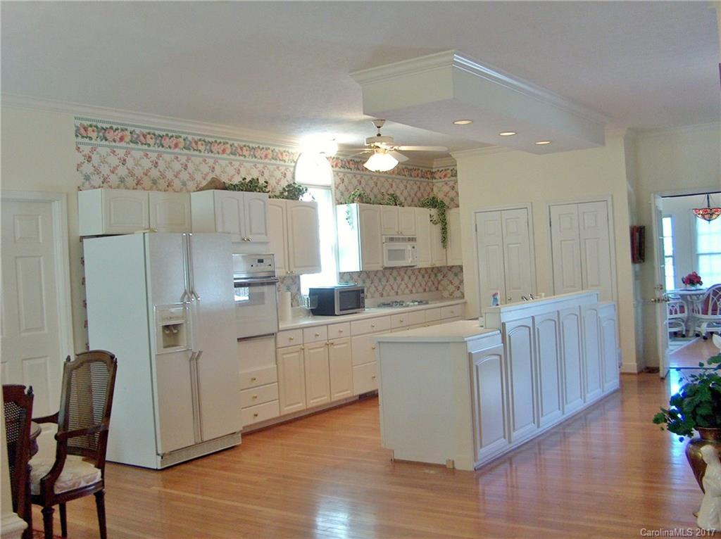 48 Falling Spring Road Clyde, NC 28721 - Photo 8 of 24 a large kitchen with cabinets wooden floor and stainless steel appliances
