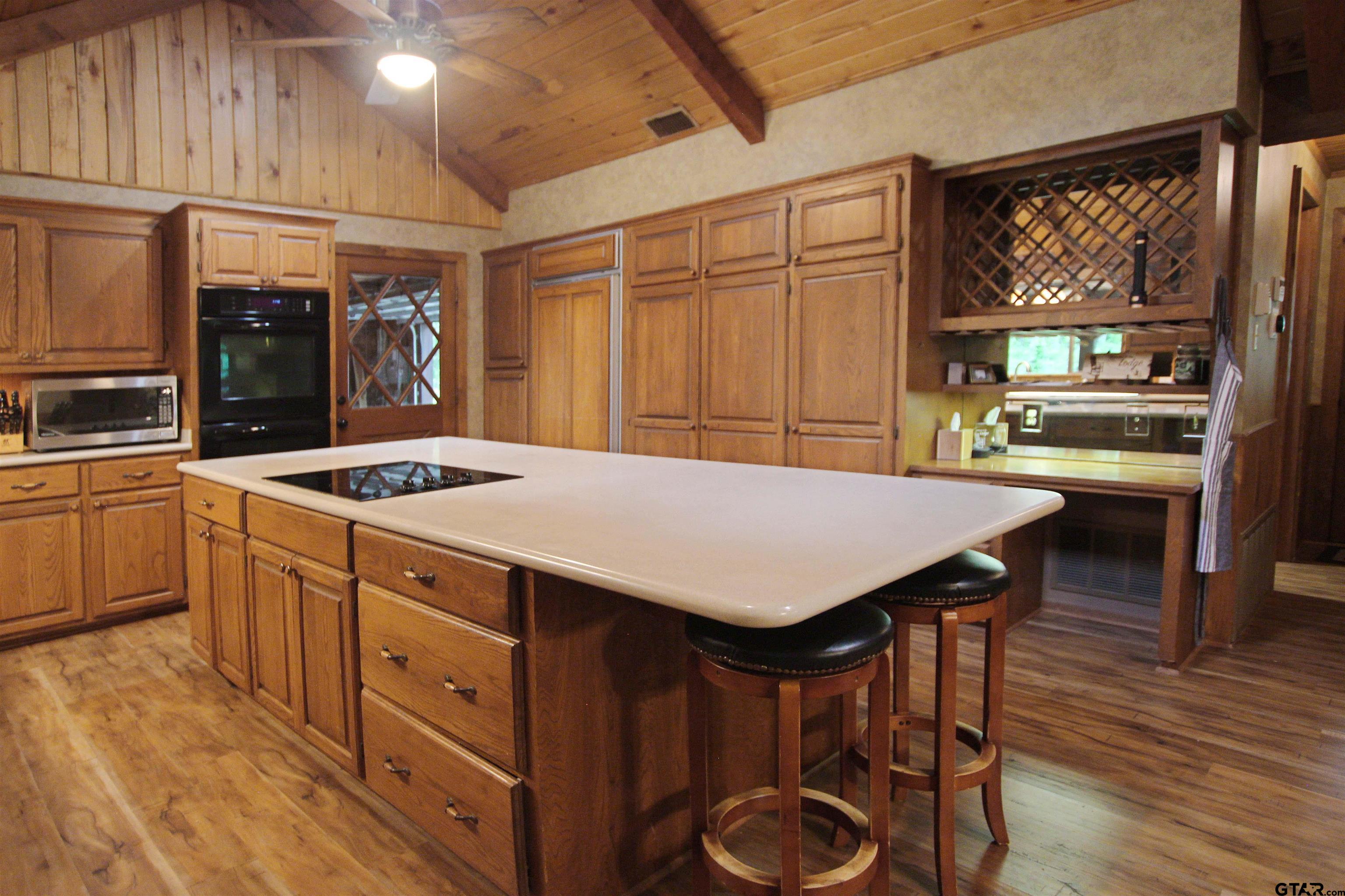 782 Rosie Wady Road Gladewater, TX 75647 - Photo 10 of 48 a kitchen with a table chairs sink and cabinets