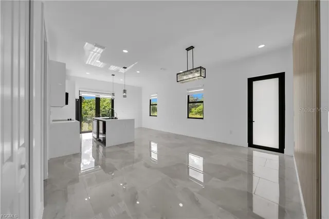 a view of a hallway with a dining table and chairs