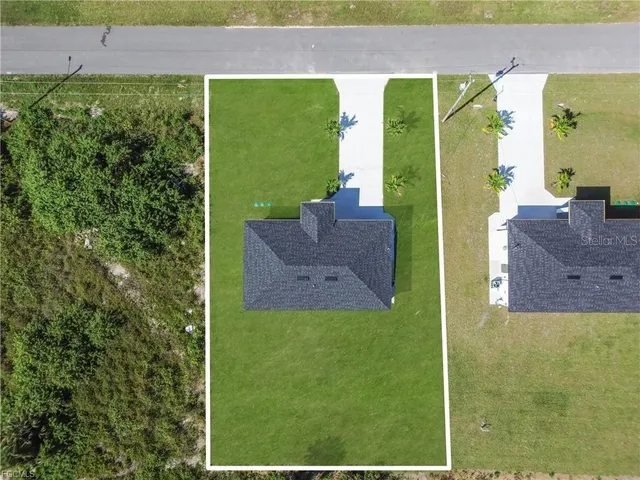 an aerial view of a house with yard swimming pool and outdoor seating