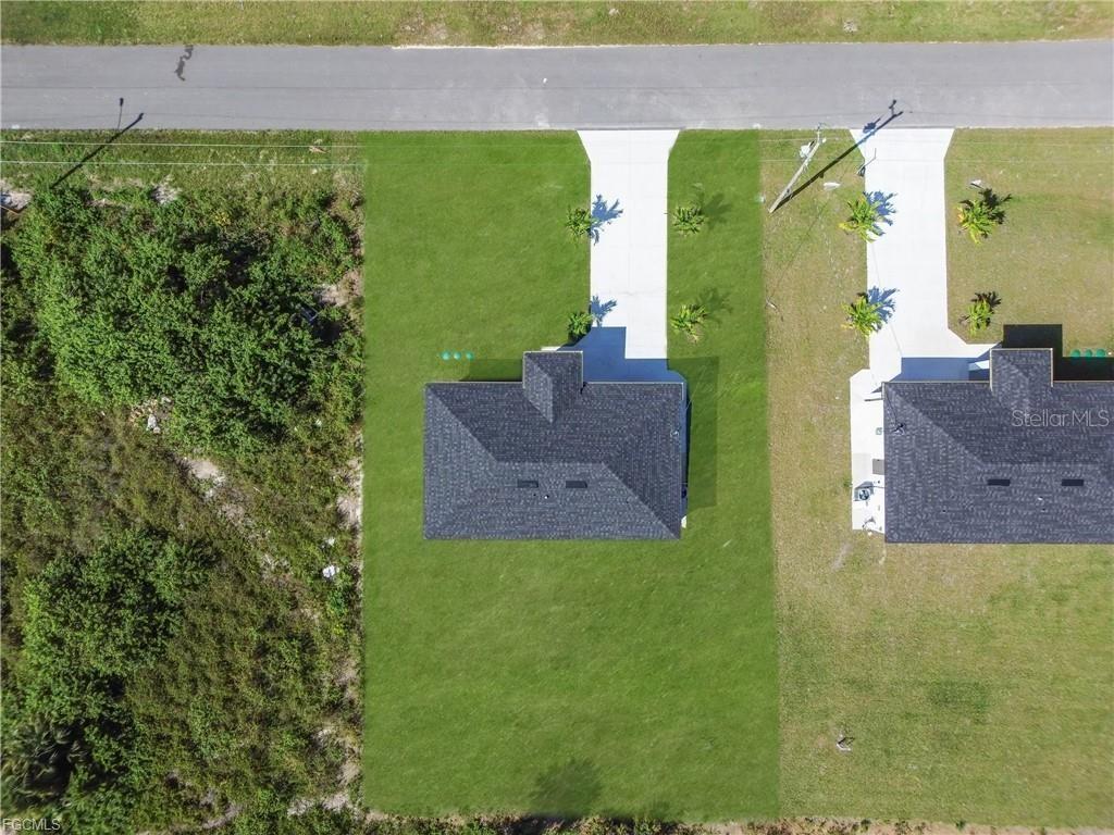 713 Roma Avenue South Lehigh Acres, FL 33974 - Photo 36 of 38 a view of a big yard with potted plants