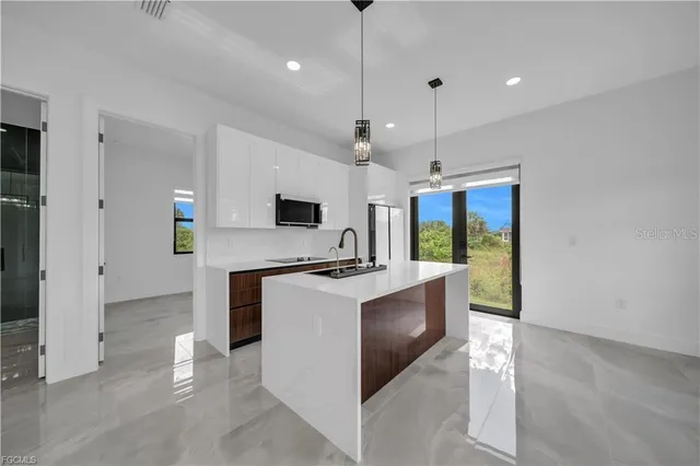 a view of kitchen with stove and refrigerator