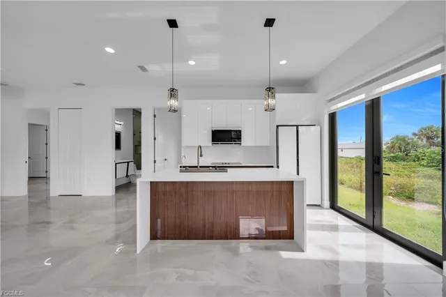 a view of a kitchen with a sink and a fireplace