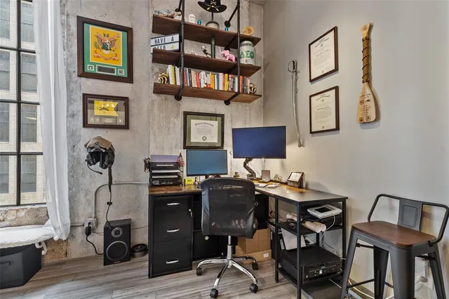 a view of a workspace with furniture and wooden floor