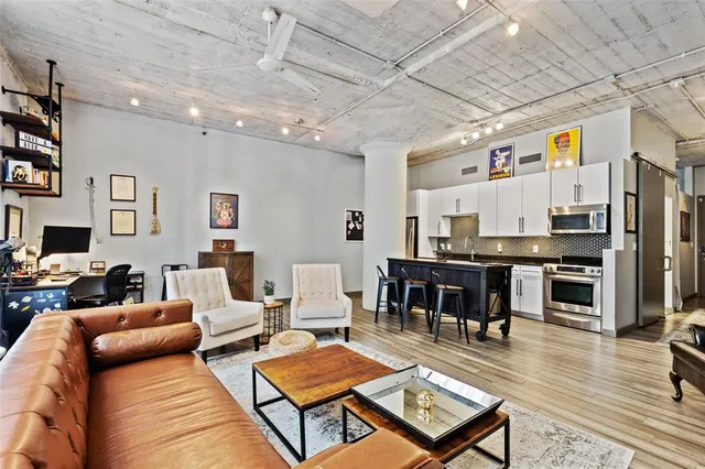 a living room with furniture kitchen view and a table