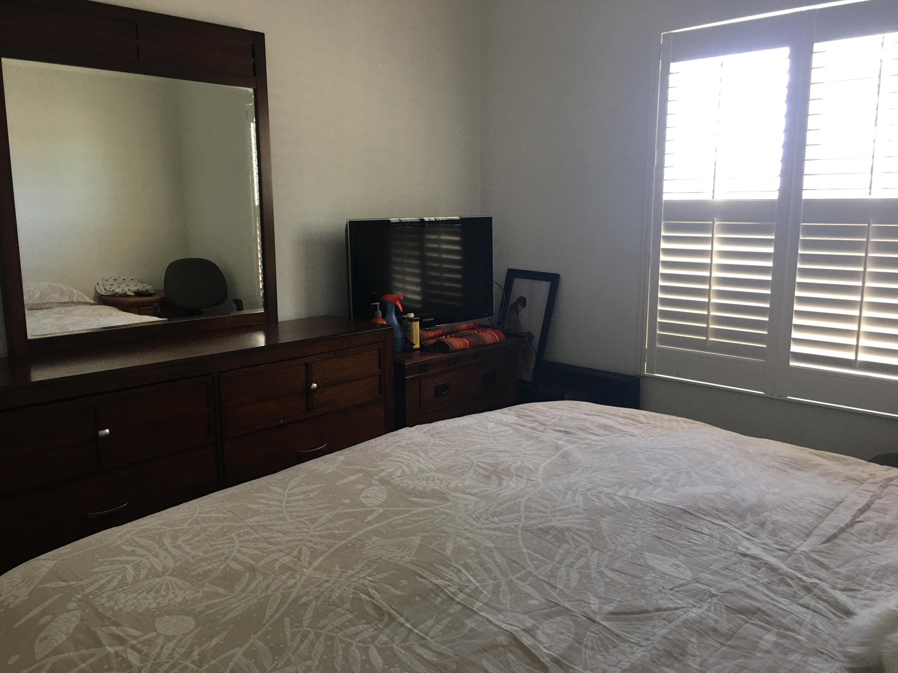 67874 Rio Largo Road Cathedral City, CA 92234 - Photo 12 of 20 a bedroom with a bed and a flat tv screen on the dresser