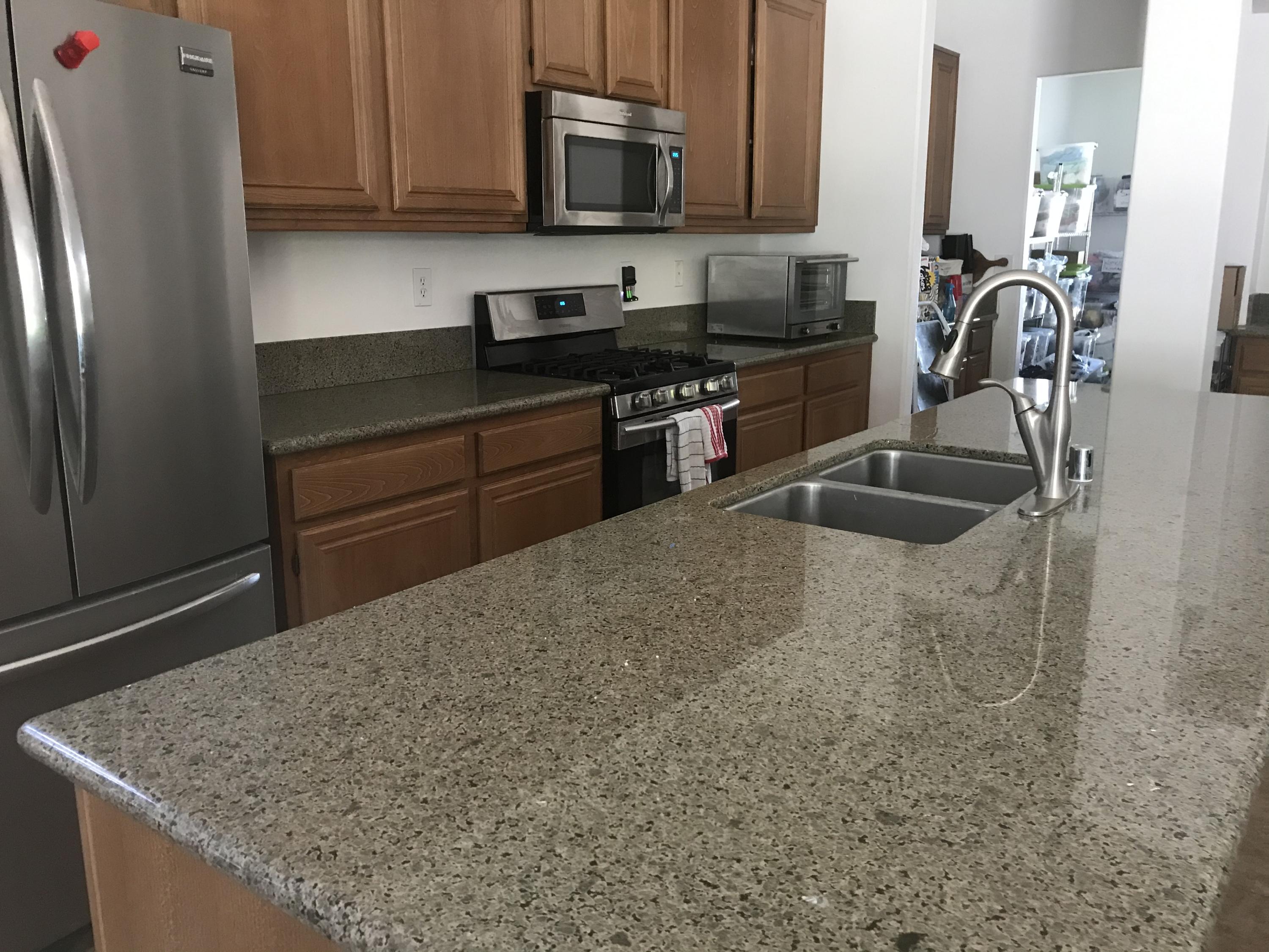67874 Rio Largo Road Cathedral City, CA 92234 - Photo 6 of 20 a kitchen with stainless steel appliances granite countertop a sink stove and microwave