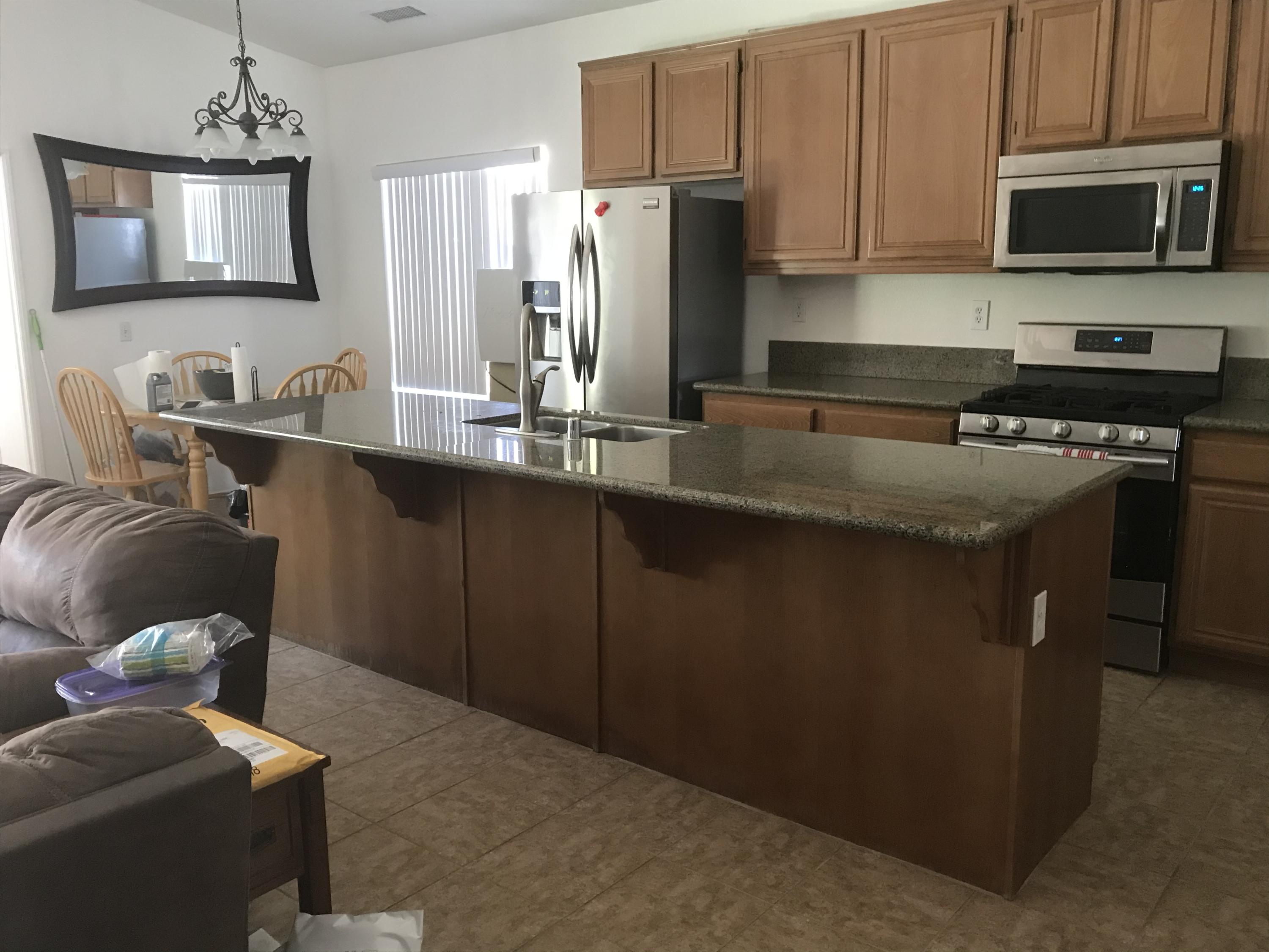 67874 Rio Largo Road Cathedral City, CA 92234 - Photo 8 of 20 a kitchen with stainless steel appliances granite countertop a sink a stove a refrigerator a washer and dryer