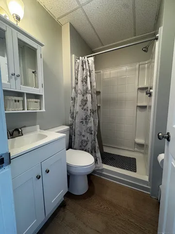 a bathroom with a toilet sink and shower