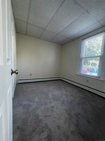 an empty room with a empty space and windows