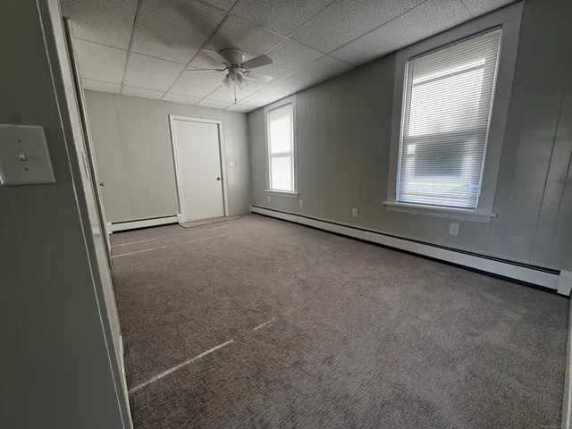 an empty room with a empty space and windows