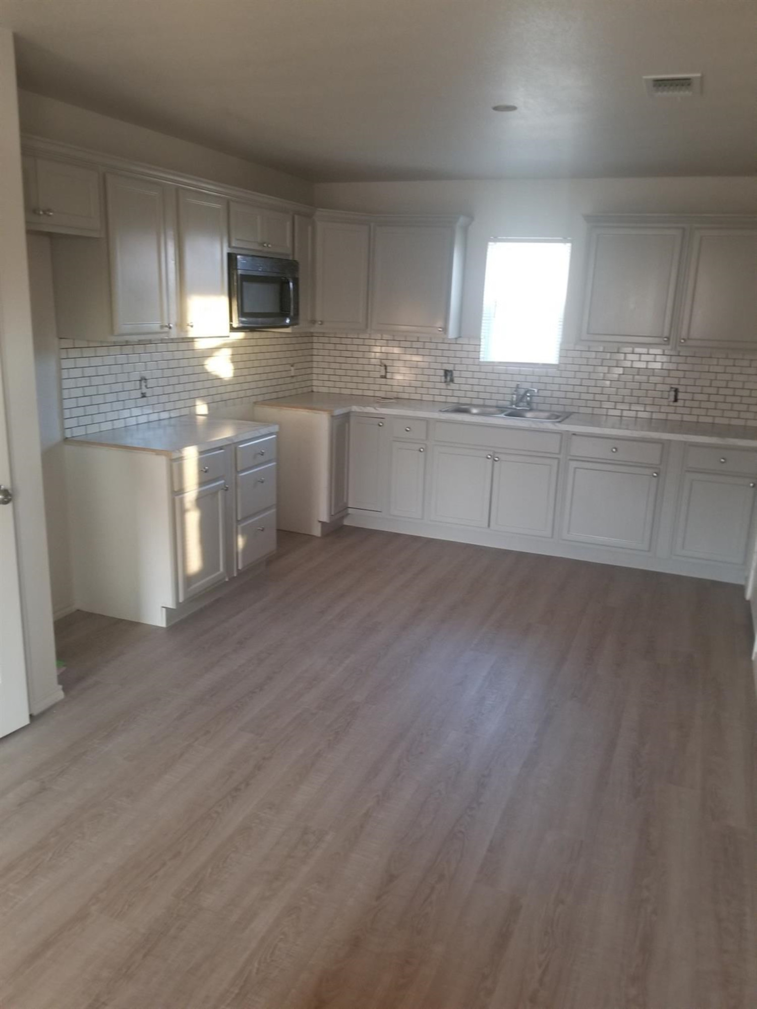1724 27th Street Lubbock, TX 79411 - Photo 2 of 7 a kitchen with stainless steel appliances granite countertop a sink a stove a refrigerator and cabinets