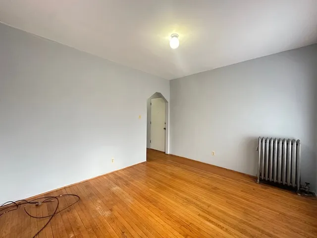 a view of an empty room and wooden floor