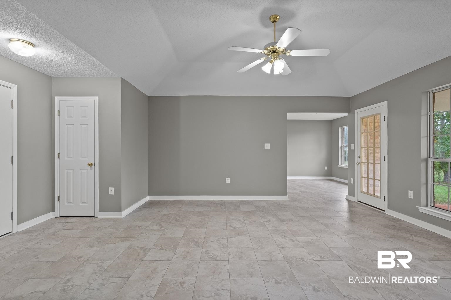 16418 Avent Lane Foley, AL 36535 - Photo 14 of 30 Empty room featuring vaulted ceiling, ceiling fan, and a textured ceiling