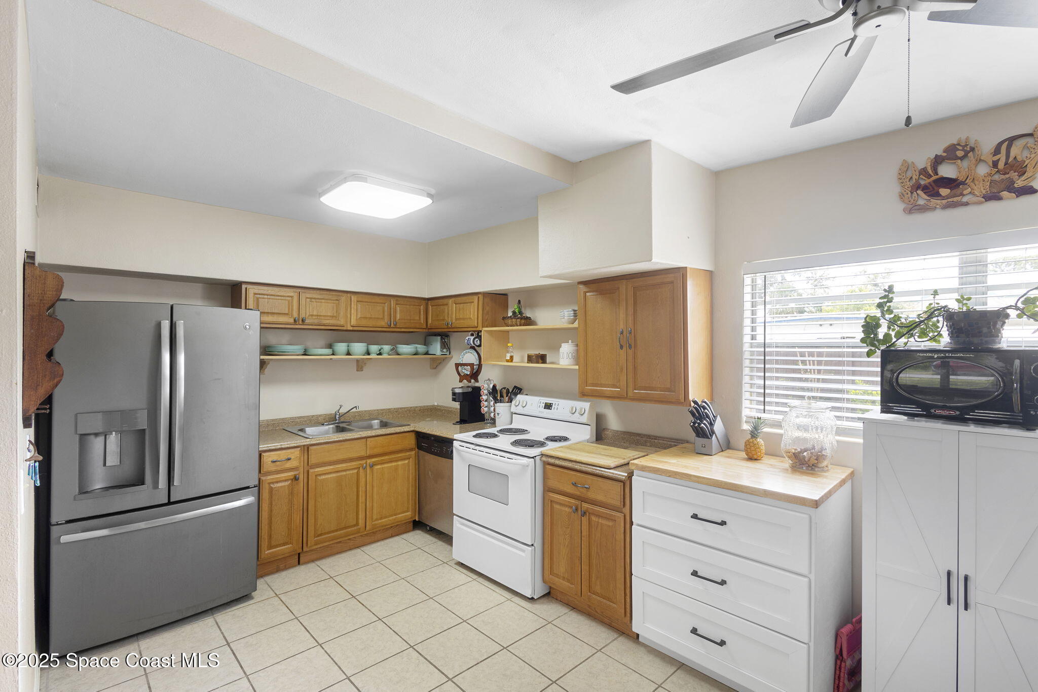 4535 Moon Road Titusville, FL 32780 - Photo 11 of 37 a kitchen with a stove a sink and a refrigerator