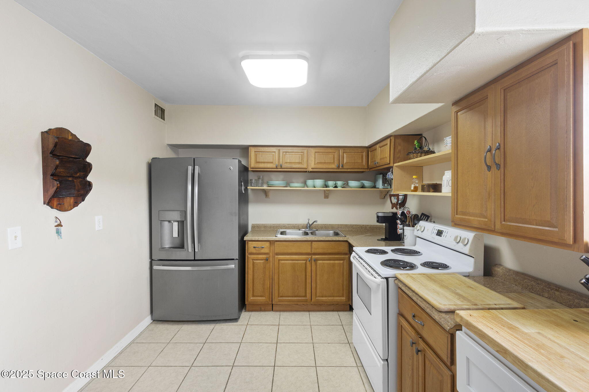4535 Moon Road Titusville, FL 32780 - Photo 13 of 37 a kitchen with a stove top oven and refrigerator