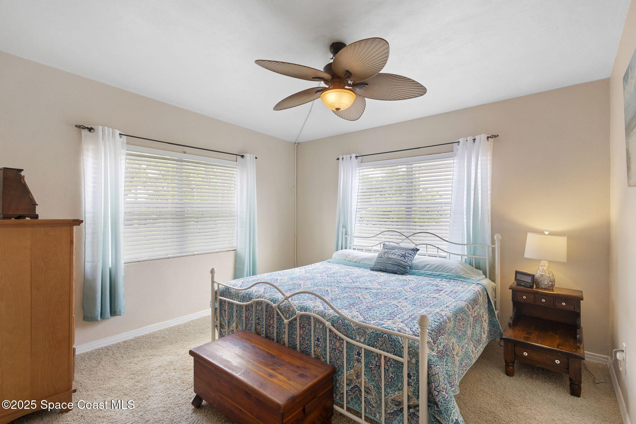 4535 Moon Road Titusville, FL 32780 - Photo 15 of 37 a bedroom with a bed and a chandelier
