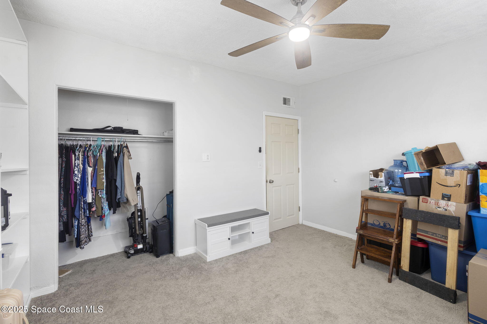 4535 Moon Road Titusville, FL 32780 - Photo 18 of 37 a view of a workspace with furniture and a ceiling fan
