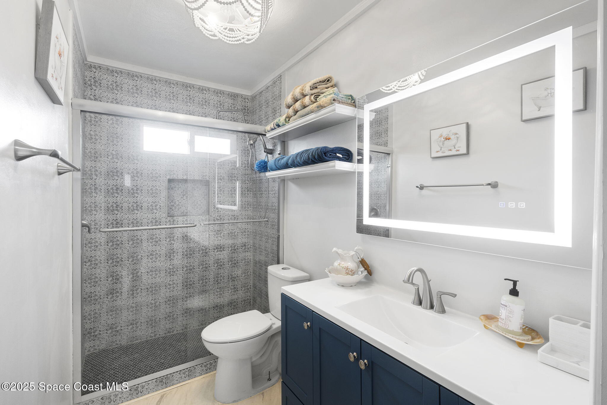 4535 Moon Road Titusville, FL 32780 - Photo 19 of 37 a bathroom with a sink toilet and shower