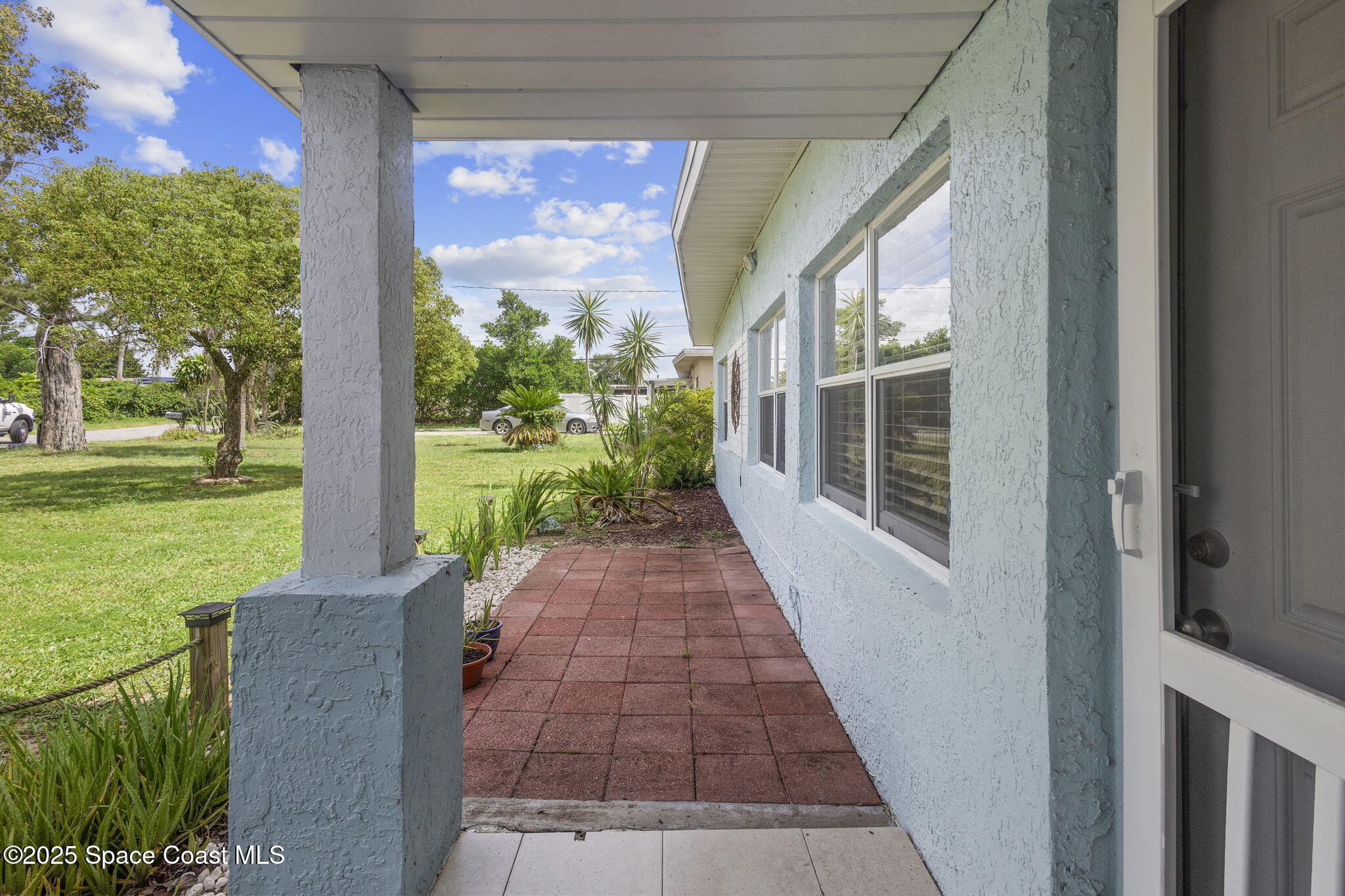 4535 Moon Road Titusville, FL 32780 - Photo 24 of 37 a view of a porch with a yard