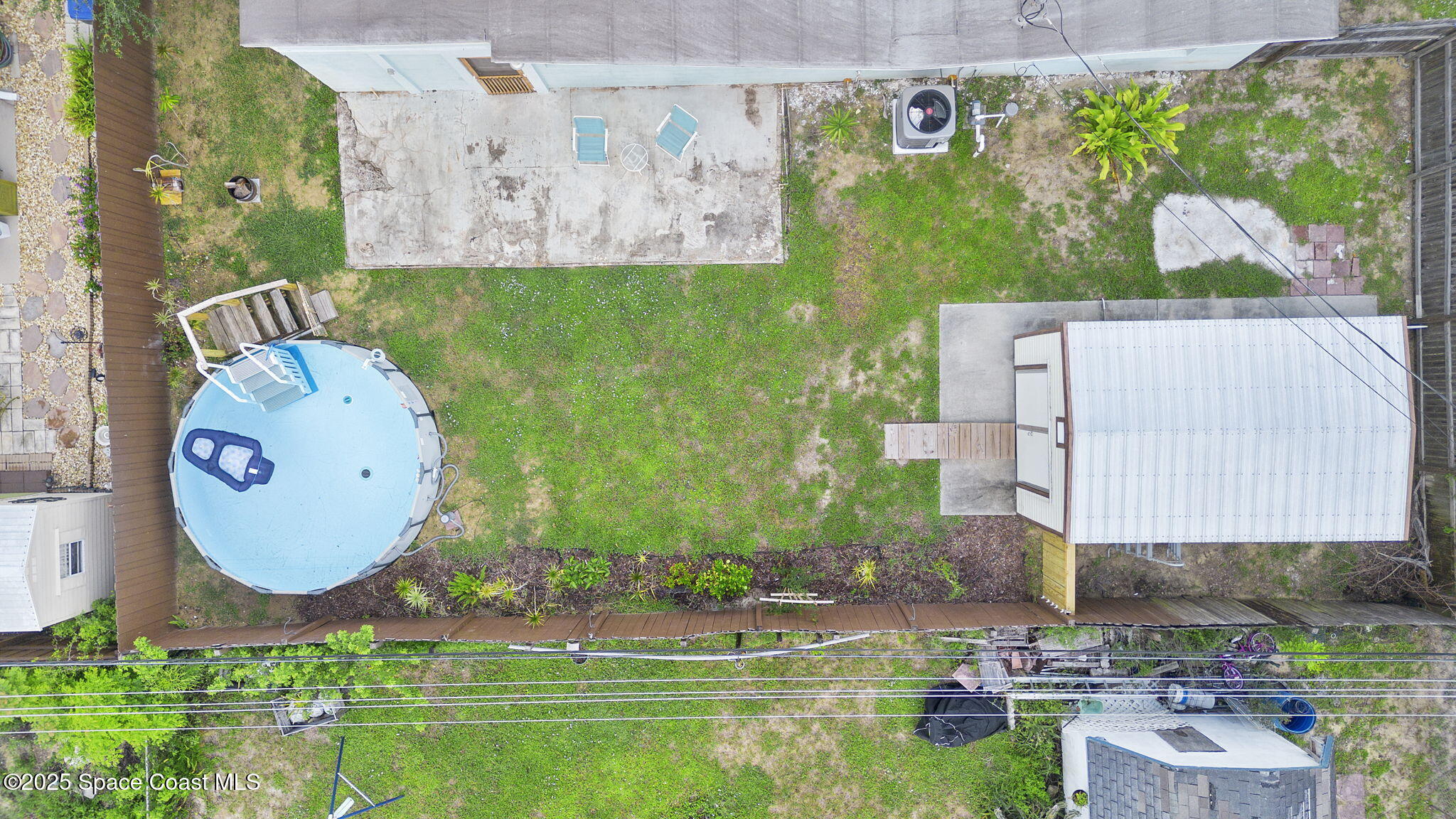 4535 Moon Road Titusville, FL 32780 - Photo 26 of 37 a aerial view of a house with garden space and sitting space