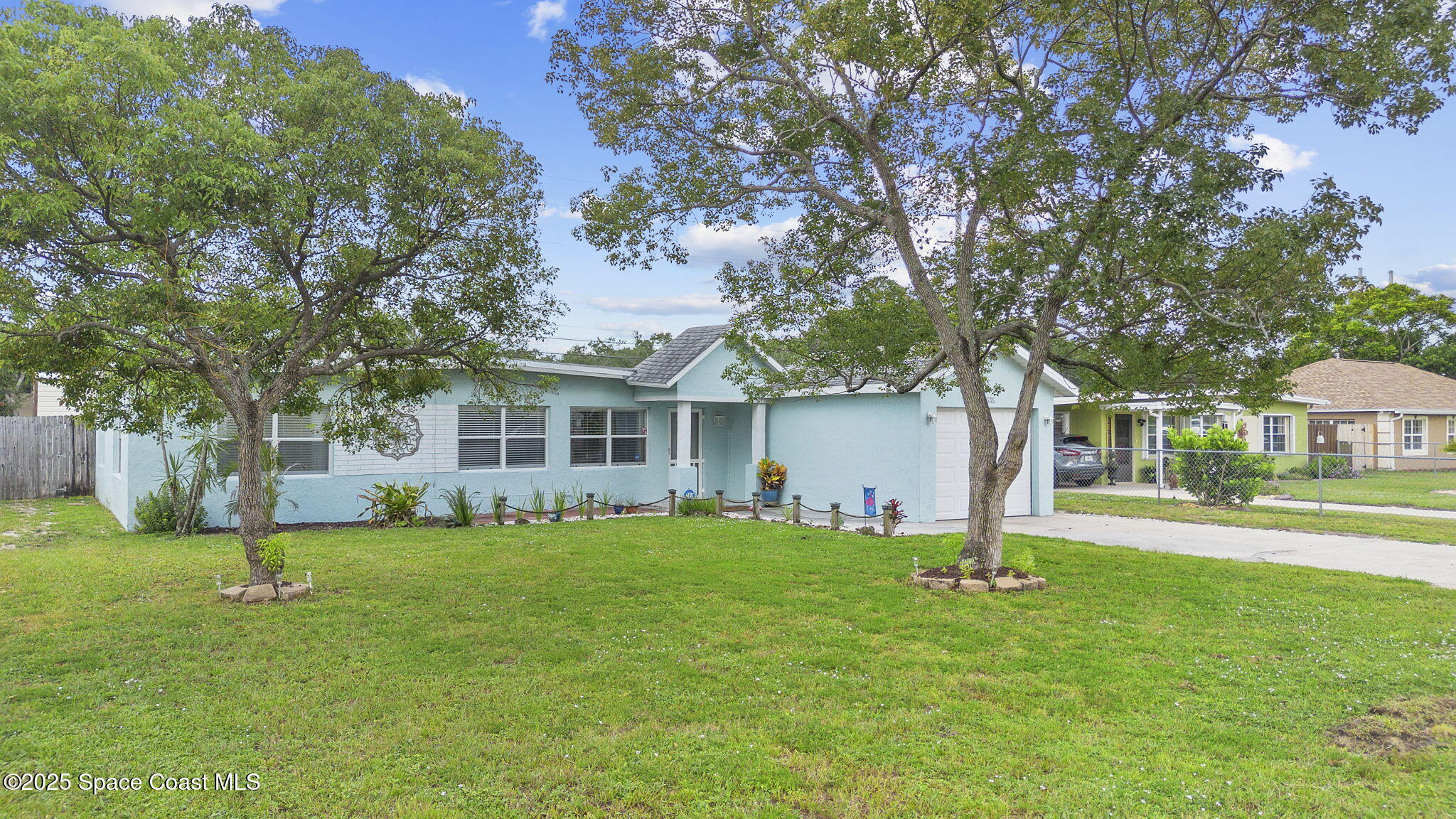 4535 Moon Road Titusville, FL 32780 - Photo 28 of 37 a front view of a house with a yard and trees