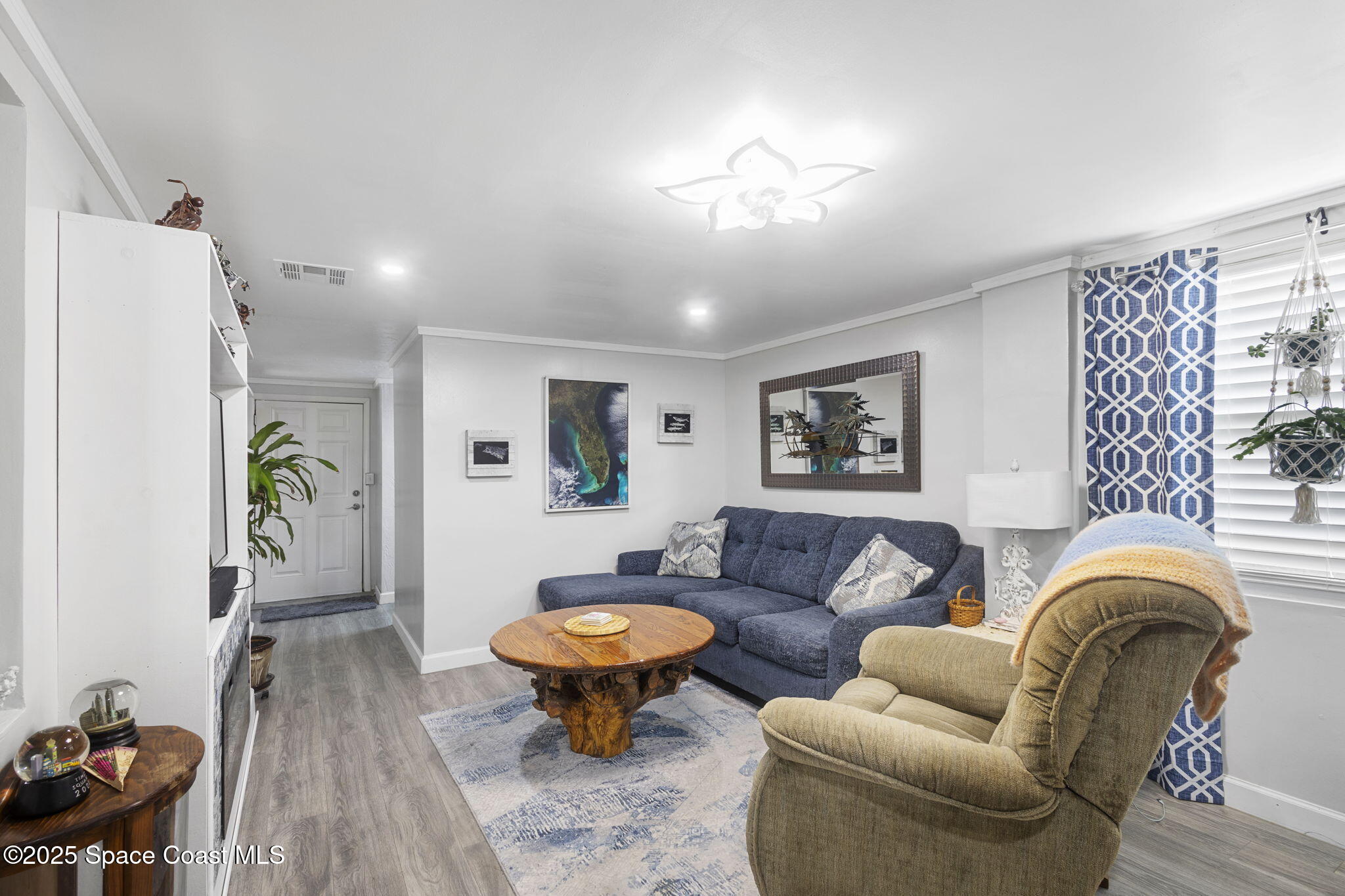 4535 Moon Road Titusville, FL 32780 - Photo 3 of 37 a living room with furniture a rug and a window