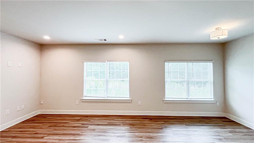 740 Eudora Welty Way Athens, GA 30607 - Photo 8 of 57 an empty room with wooden floor and windows