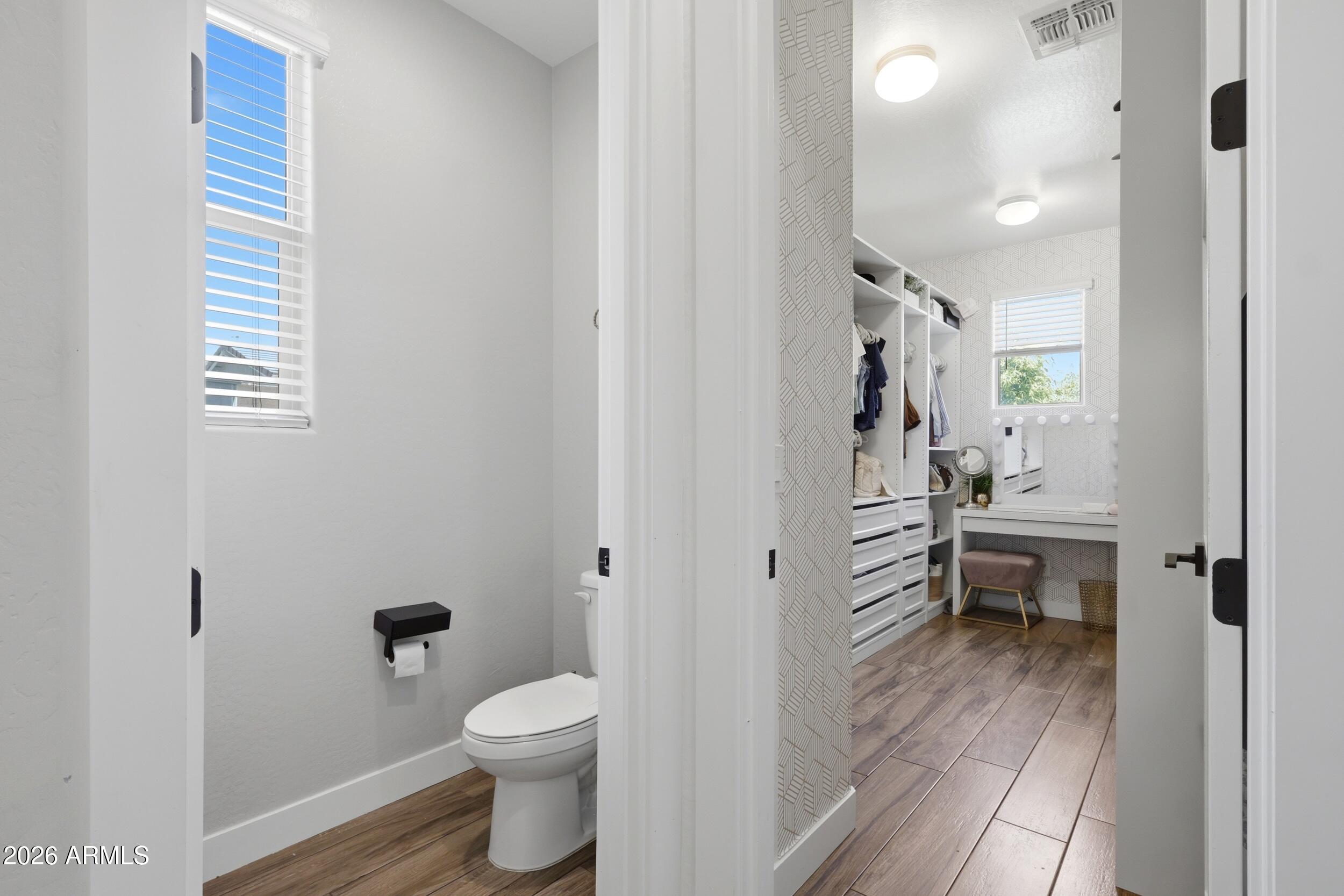 12517 West Lawrence Road Glendale, AZ 85307 - Photo 32 of 52 a bathroom with a toilet and a hardwood floor