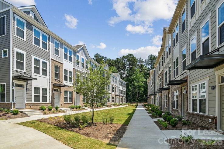 4375 Raleigh Street, Unit C1 Charlotte, NC 28213 - Photo 2 of 19 a view of a building with a yard