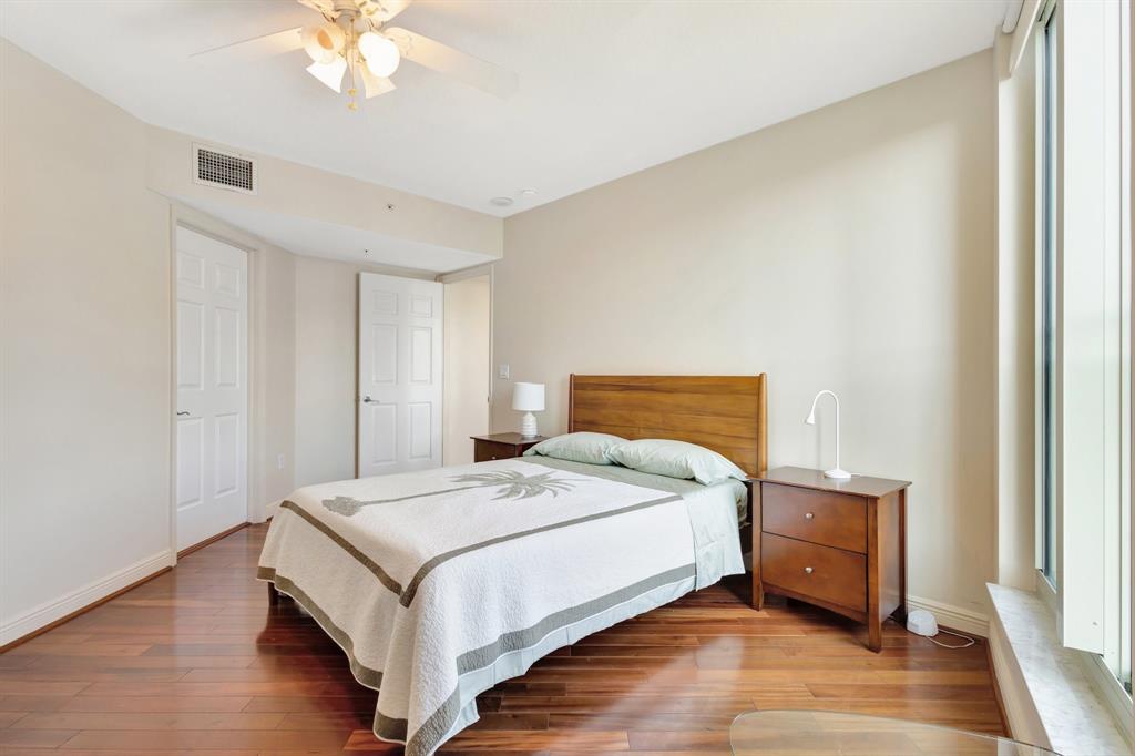 610 Clematis Street, Unit 412 West Palm Beach, FL 33401 - Photo 14 of 52 a bedroom with a bed and a chandelier