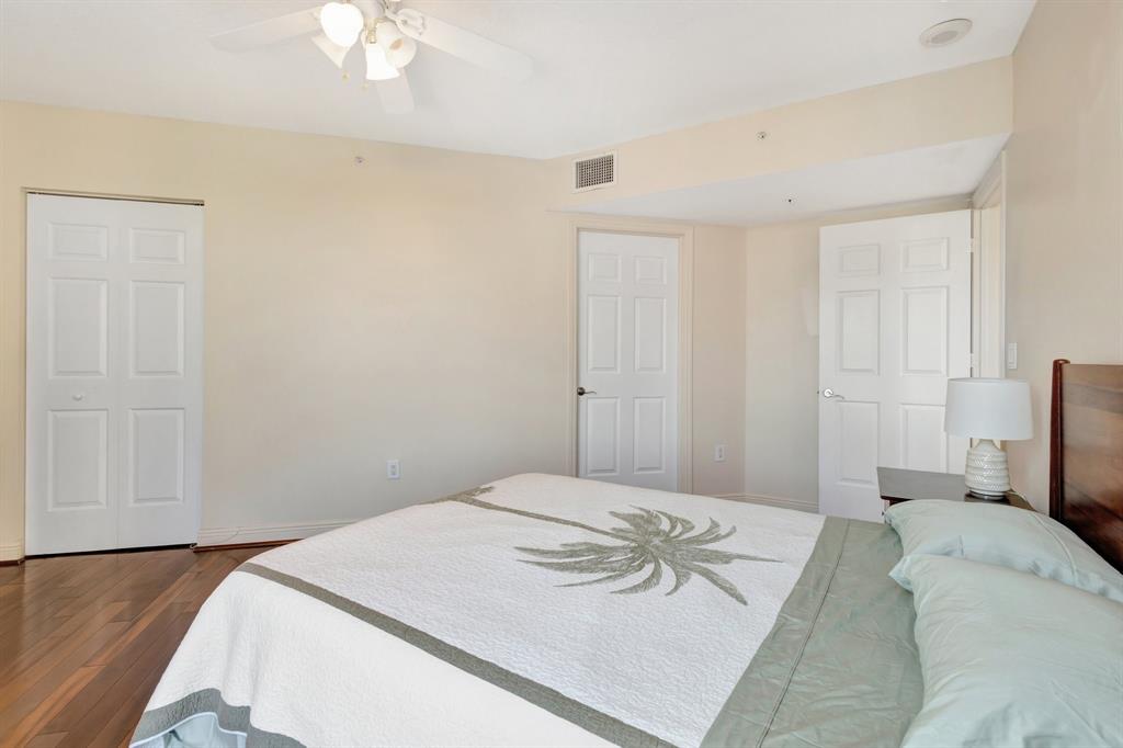 610 Clematis Street, Unit 412 West Palm Beach, FL 33401 - Photo 15 of 52 a bedroom with a bed and a chandelier