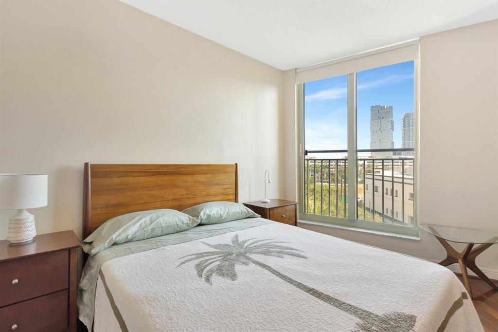 610 Clematis Street, Unit 412 West Palm Beach, FL 33401 - Photo 16 of 52 a bedroom with a bed and a large window