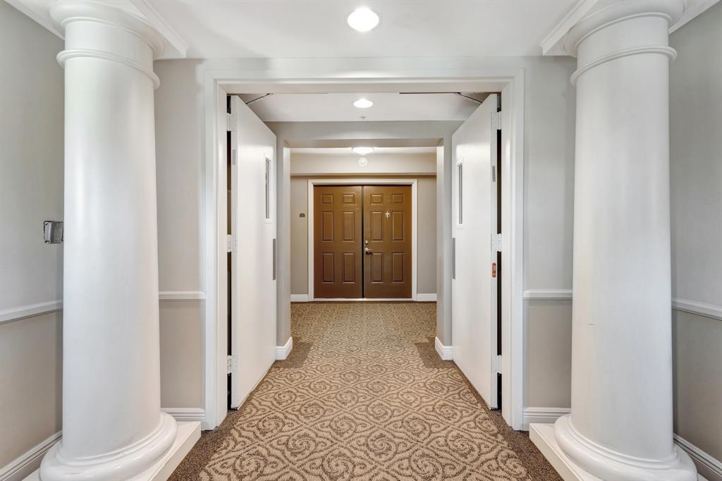 610 Clematis Street, Unit 412 West Palm Beach, FL 33401 - Photo 2 of 52 a view of a hallway with wooden floor and a bathroom