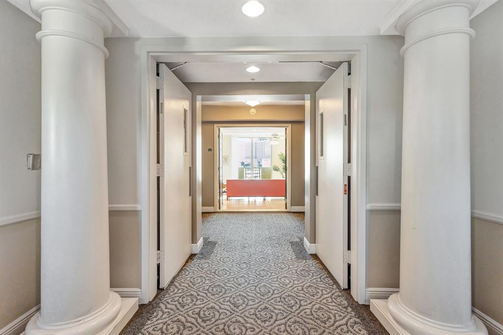 610 Clematis Street, Unit 412 West Palm Beach, FL 33401 - Photo 3 of 52 a view of a hallway with wooden floor and a bathroom
