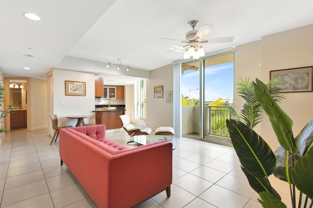 610 Clematis Street, Unit 412 West Palm Beach, FL 33401 - Photo 7 of 52 a living room with furniture and a chandelier