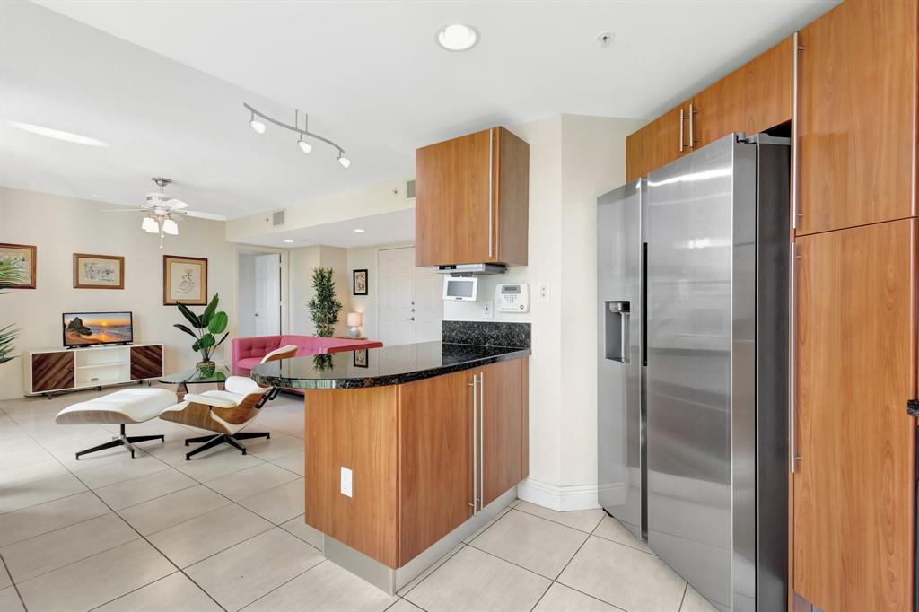 610 Clematis Street, Unit 412 West Palm Beach, FL 33401 - Photo 10 of 52 a kitchen with stainless steel appliances a refrigerator and cabinets
