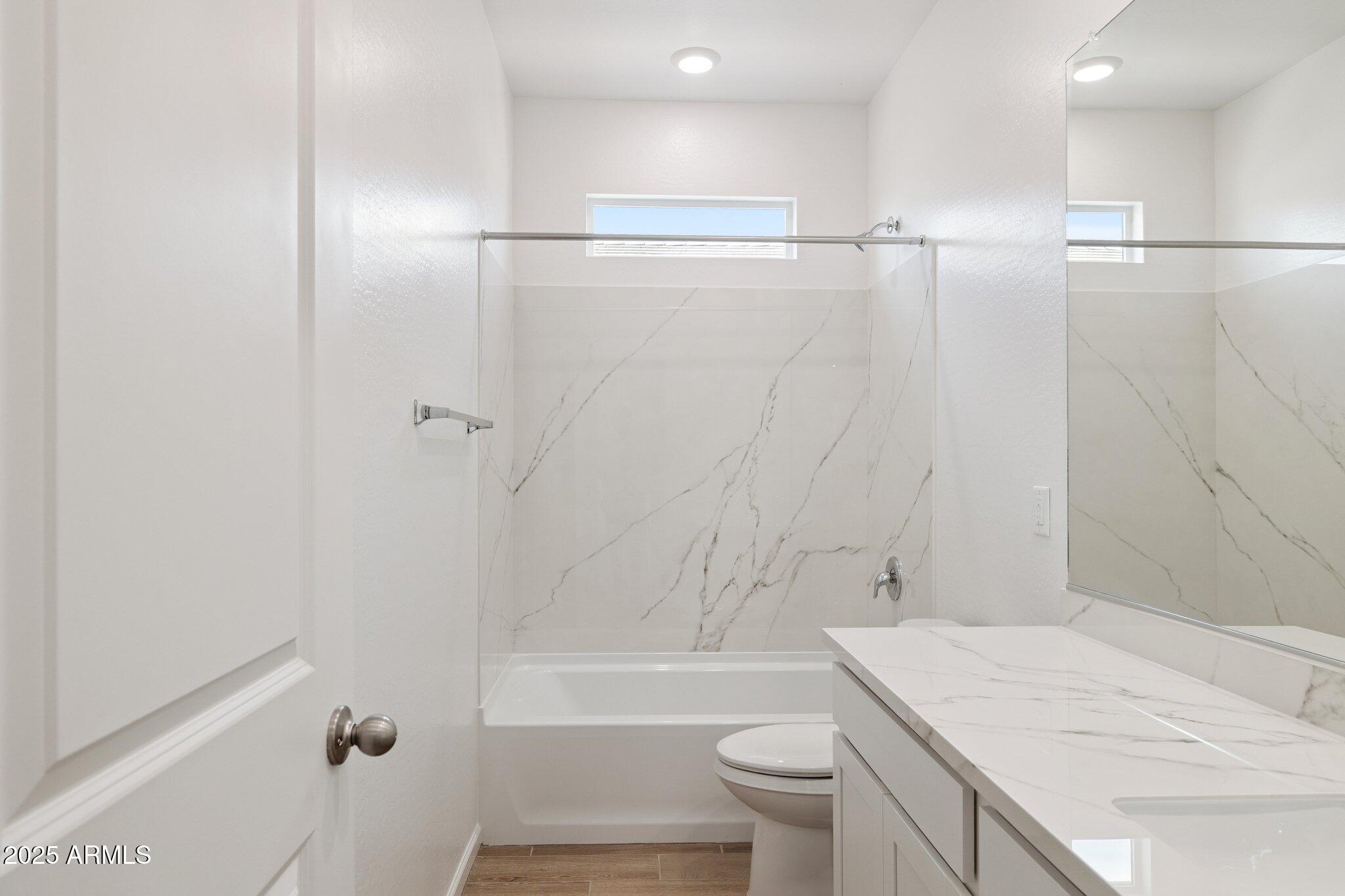 25459 West Fraktur Road Buckeye, AZ 85326 - Photo 11 of 14 a bathroom with a sink a toilet and shower