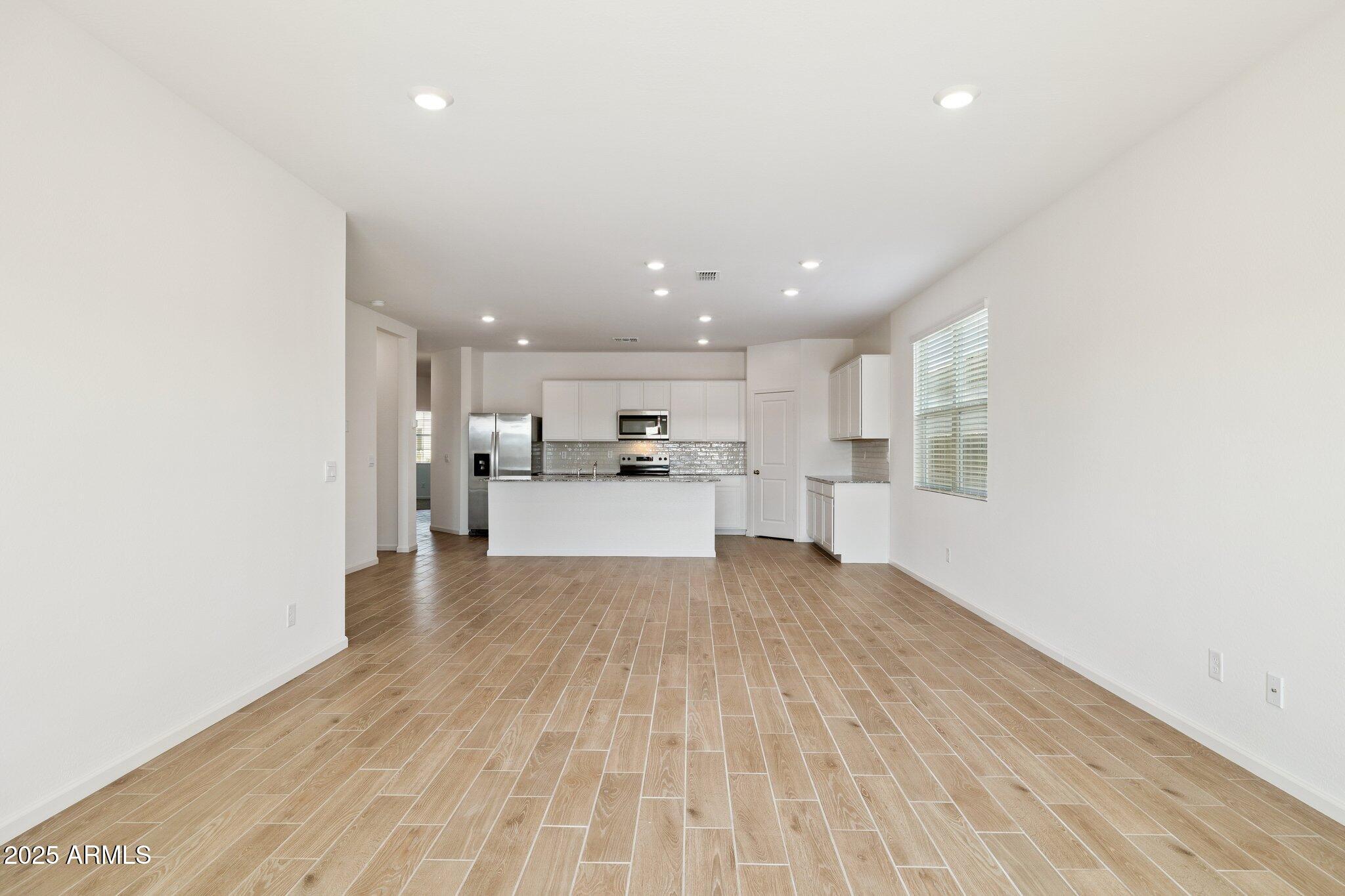 25459 West Fraktur Road Buckeye, AZ 85326 - Photo 3 of 14 a view of kitchen with wooden floor