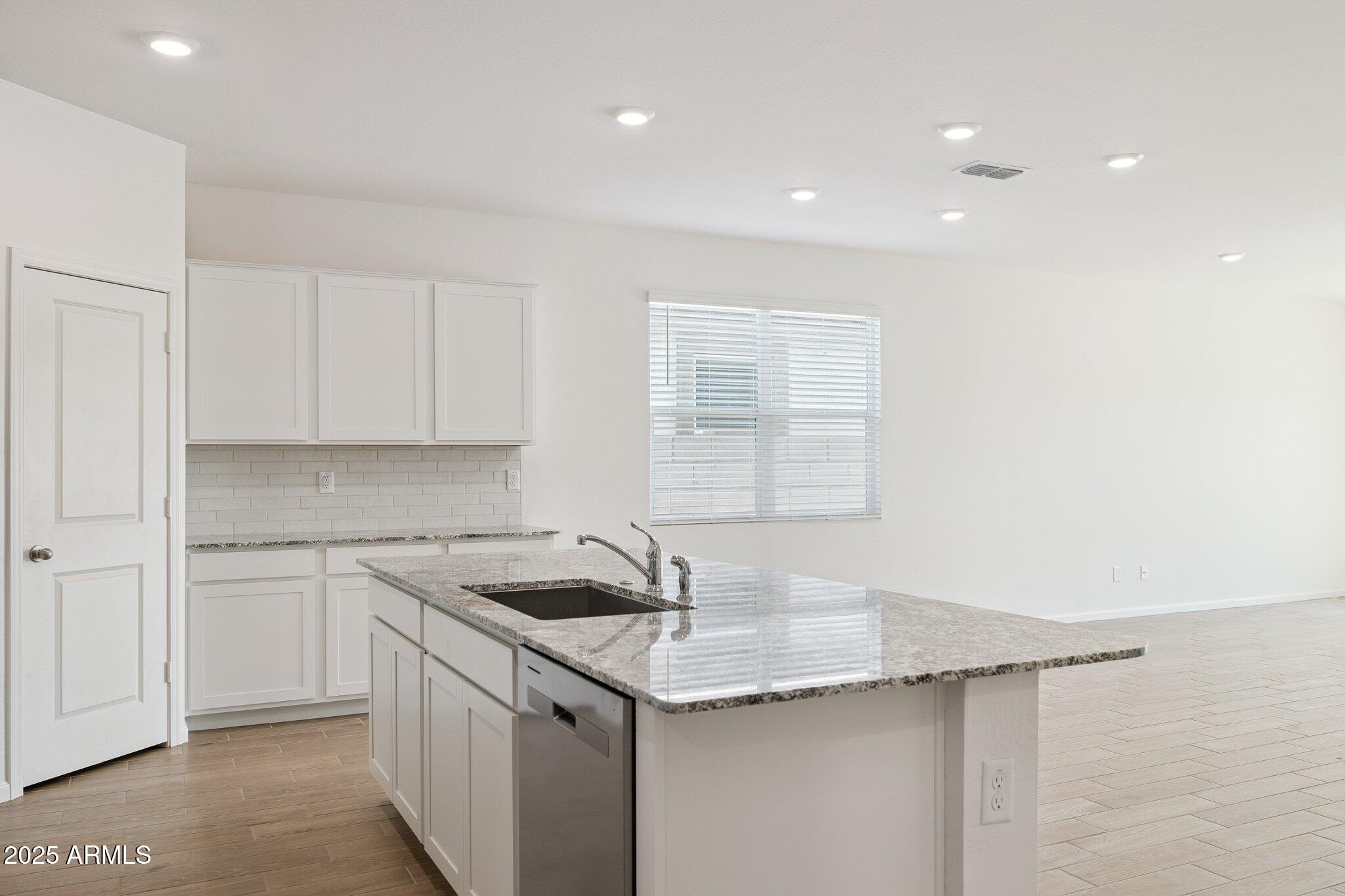 25459 West Fraktur Road Buckeye, AZ 85326 - Photo 4 of 14 a kitchen with a sink and cabinets