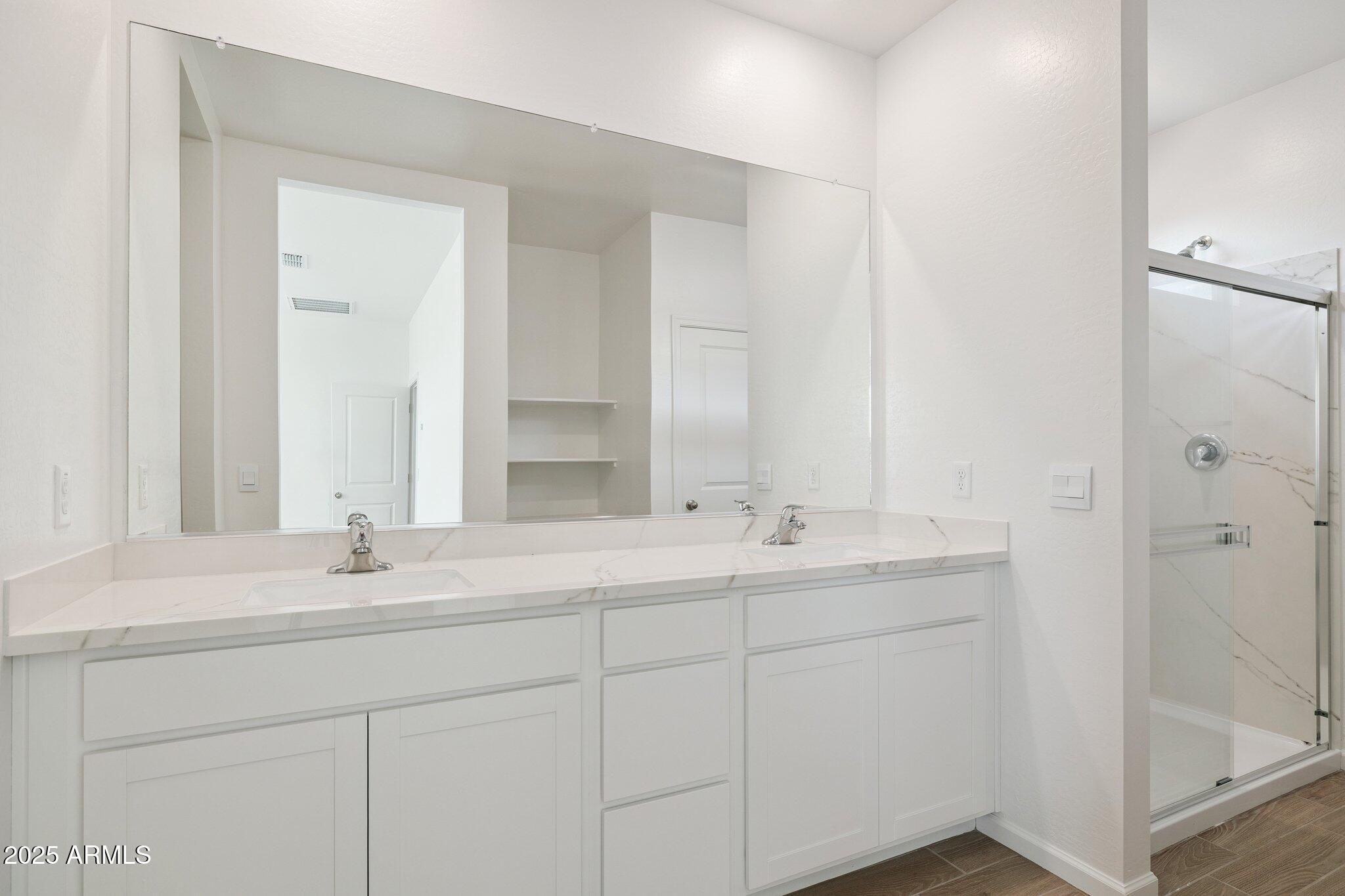 25459 West Fraktur Road Buckeye, AZ 85326 - Photo 7 of 14 a bathroom with a sink and a mirror