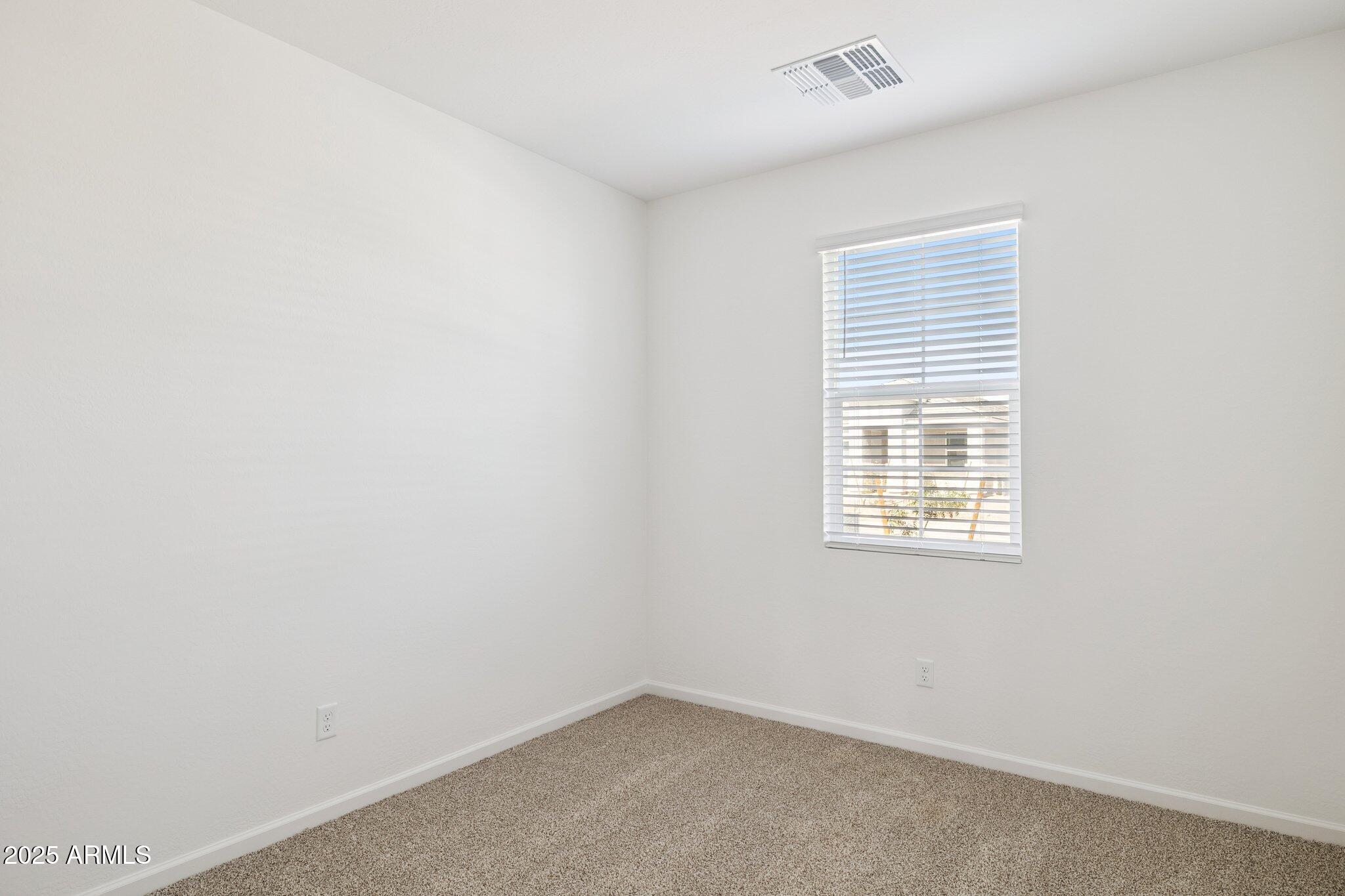 25459 West Fraktur Road Buckeye, AZ 85326 - Photo 8 of 14 an empty room with a window