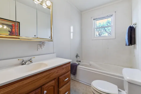 a bathroom with a sink a toilet and bathtub