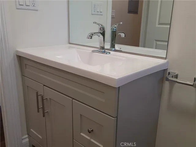 a bathroom with a sink and mirror
